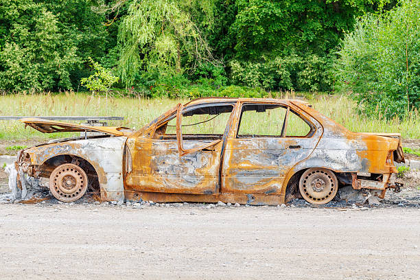 istock Burned down car wreck on the side of the road 588358234