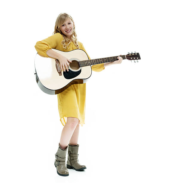 istock Smiling little girl playing guitar 588358628