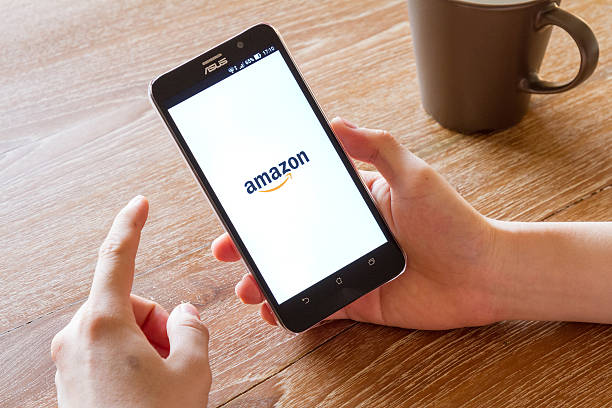 man hand holding screen shot of Amazon application stock photo