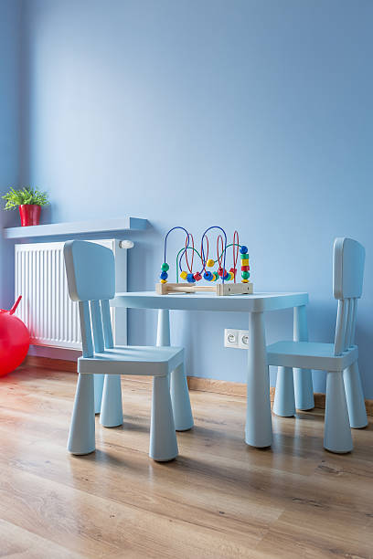 Cute multiracial little boy sitting alone in living room at home.