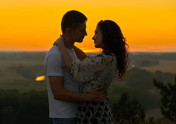 istock romantic couple looking at each other at sunset on outdoor 588362200