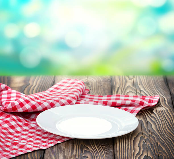 Empty white plate on wood nature blur background.