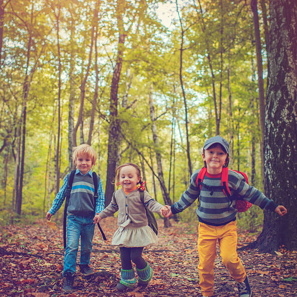 istock Little schoolchildren in autumn 588362654