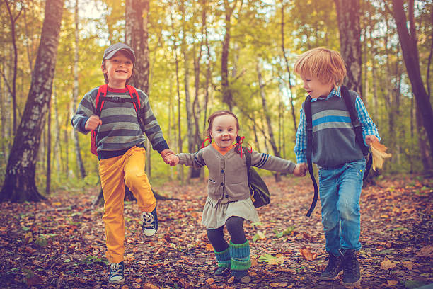 istock Little schoolchildren in autumn 588362706