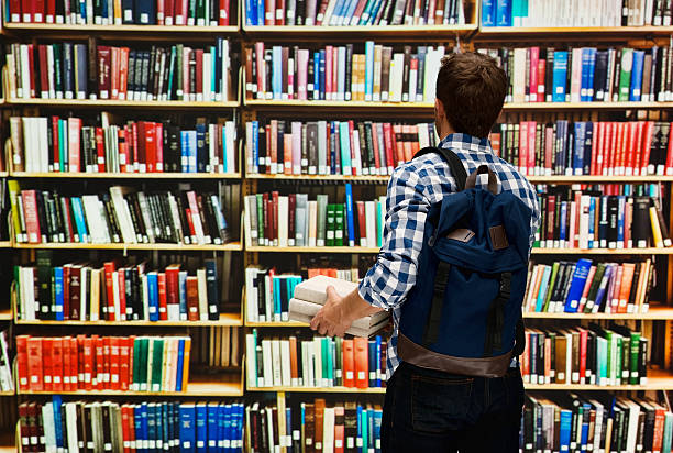istock Rear view of student standing in library 588363770