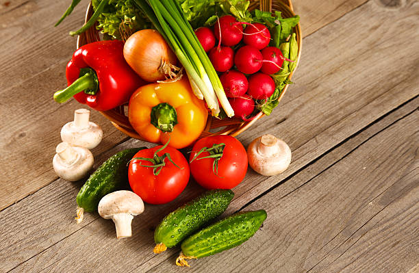 istock Fresh vegetables on a clean wooden table 588364376