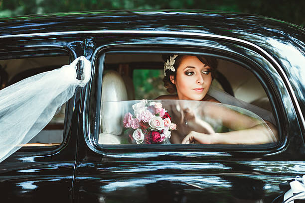 istock Bride sitting in wedding car 588364380