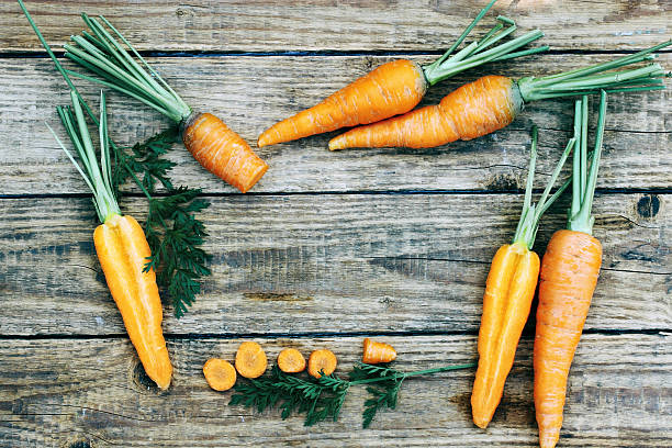 istock frame of carrots, top view 588365838