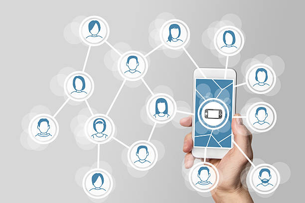 istock Mobile and social gaming concept with hand holding smartphone 588366598