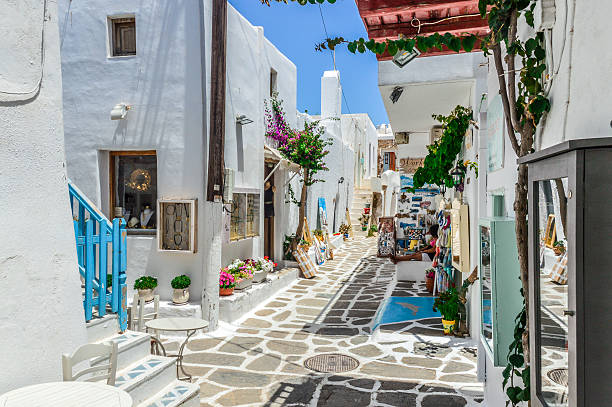 Beautiful Greek Island of Paros - Town of Naoussa Paros, Greece  - June 17, 2016: Beautiful Greek Island of Paros. Photo features a street in Naoussa with shops, cafes, restaurants, and people. paros stock pictures, royalty-free photos & images