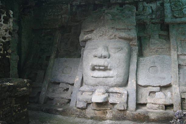 istock stone face at Mayan site of Lamanai 588367706