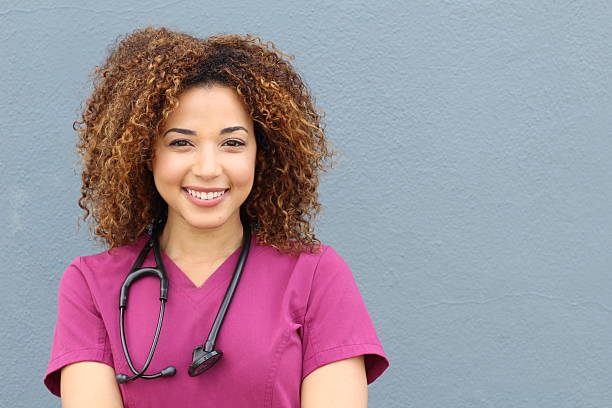 friendly nurse with stethoscope isolated on blue - doctor stethoscope healthcare worker professional occupation imagens e fotografias de stock