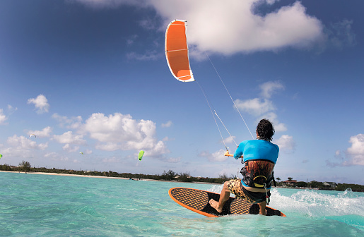 A man kite surfing in the Caribbean.