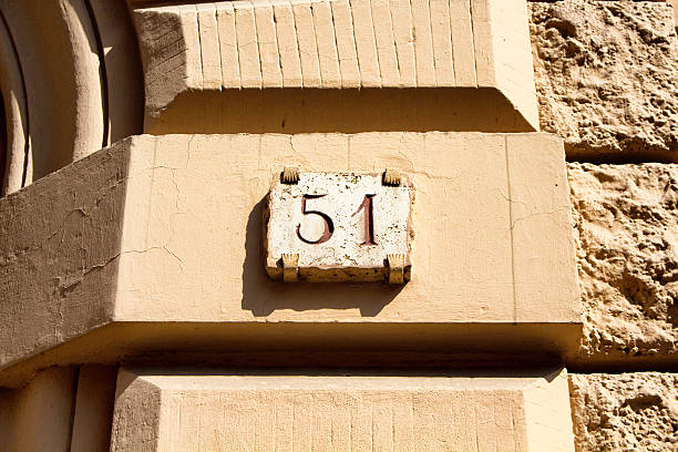 istock Engraved building number in Rome 588369438
