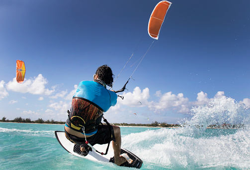 A man kite surfing in the Caribbean.