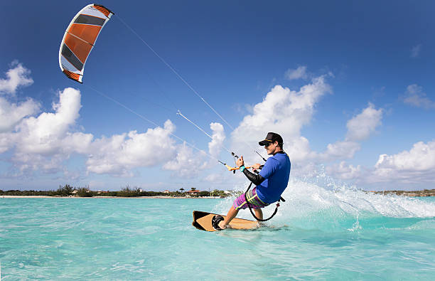 Kite Surfing Man In The Caribbean A man kite surfing in the Caribbean. kiteboarding stock pictures, royalty-free photos & images