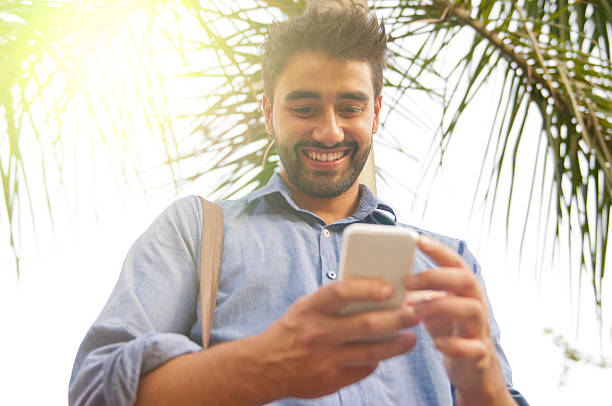 istock Picture of a handsome smiling man using his smartphone. 588371388