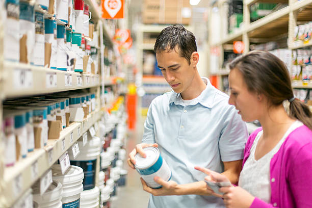 istock Human couple buying paint for a home project 588371912
