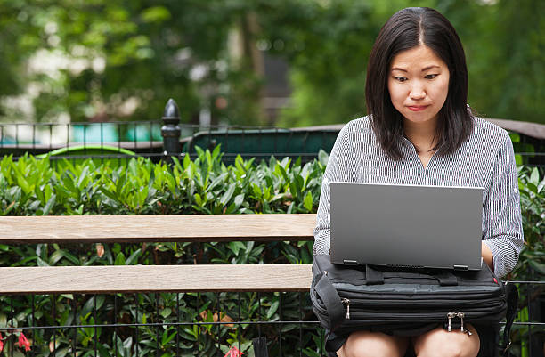 istock frustrated businesswoman sitting on park bench 588372152