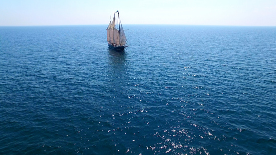 Majestic tall ship alone on a vast blue sea