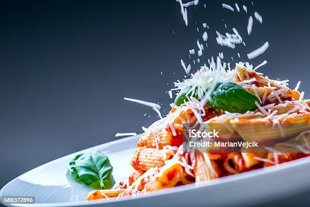 Pasta Penne With Tomato Bolognese Sauce Parmesan Cheese And Basil Stock Photo - Download Image Now