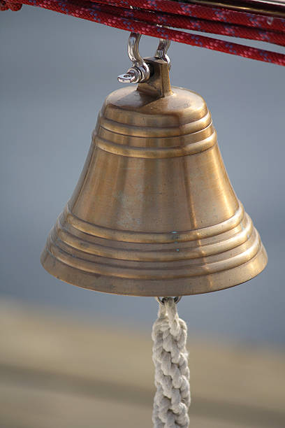 istock Bronze bell hanging on a yacht sunlit 588373154