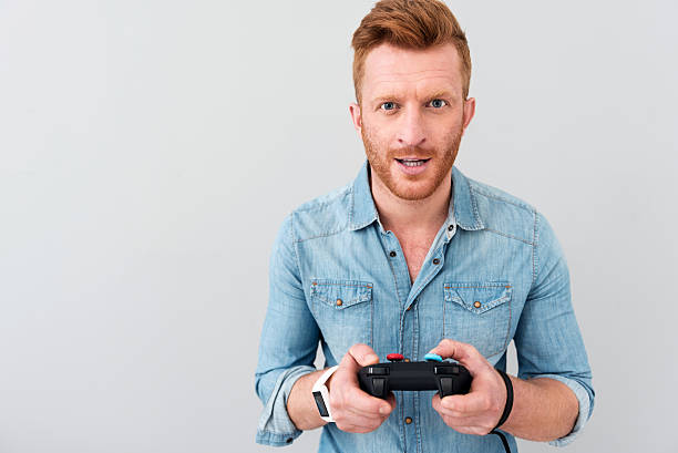 istock Cheerful man playing video games 588374668