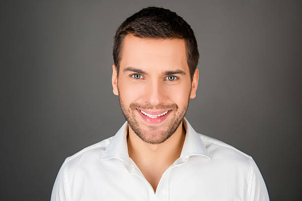 istock cheerfull young man in white shirt 588375940