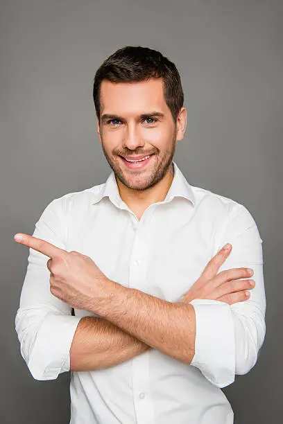 Photo of Close up photo of smaling man gesturing with crossed hands