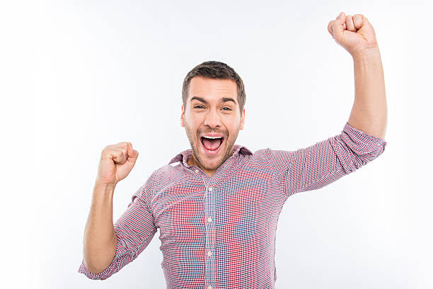 istock Attractive young man screaming and showing fists 588376140