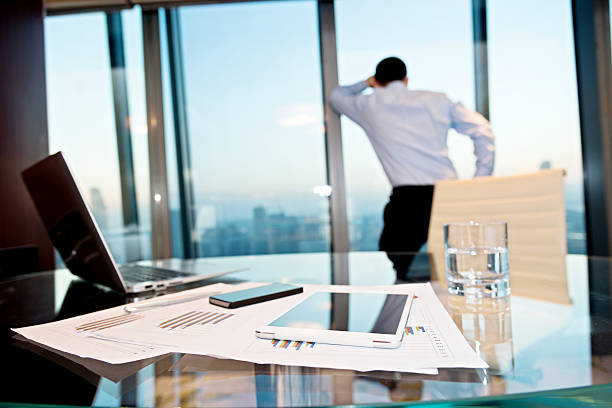 istock Businessman standing in front of window 588379960