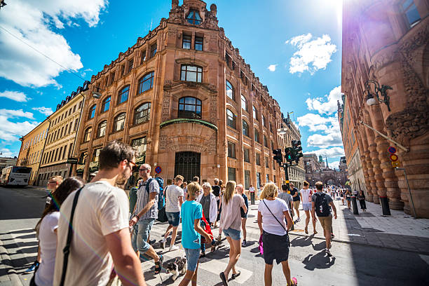 People crossing street in Stockholm, Sweden Stockholm, Sweden  - July 31, 2016: People crossing street in Stockholm, Sweden sodermalm photos stock pictures, royalty-free photos & images