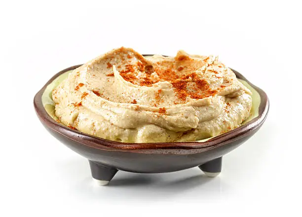 bowl of hummus isolated on white background