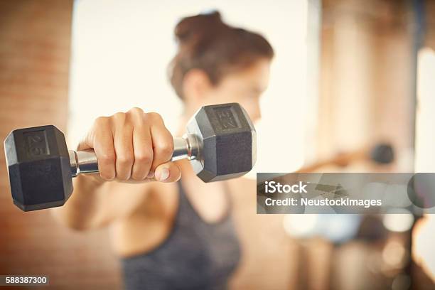 Closeup Of Dumbbell Held By Young Woman In Gym Stock Photo - Download Image Now - Dumbbell, Weight Training, Weights