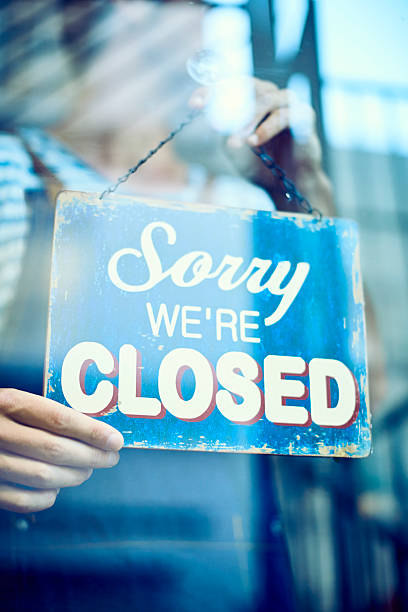 istock Waiter hanging closed sign on window 588387730
