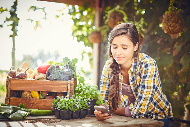 Young woman text messaging at organic farm