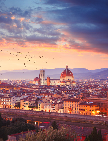 Italian town Florence (Firenze) by dusk, Florence Cathedral in the middle, Apennine mountains on the background