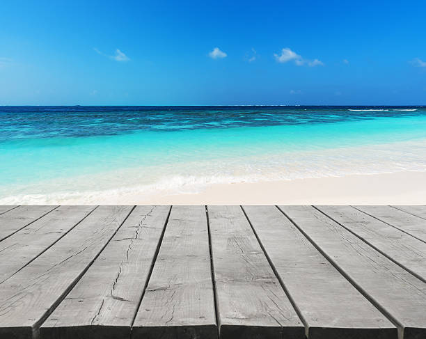 istock Wooden terrace beside tropical beach 588389206