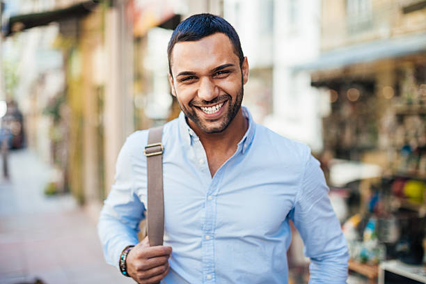 Young and happy Cheerful young man walking on the street. middle eastern culture photos stock pictures, royalty-free photos & images