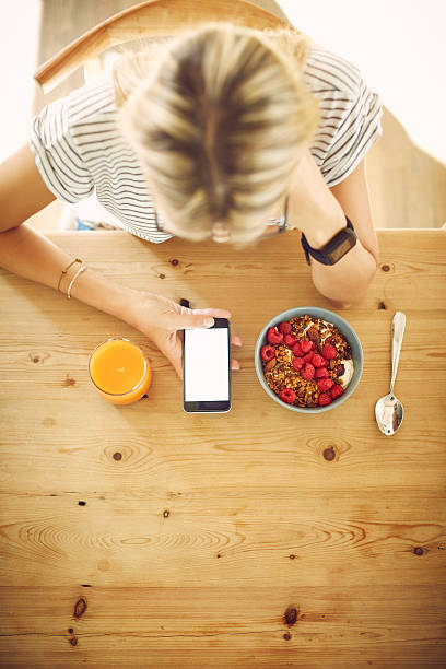istock Blogger with blank screen smart phone and breakfast at table 588389734