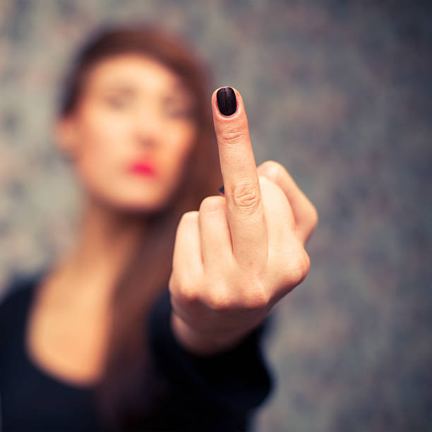istock girl showing middle finger gesture 588390938