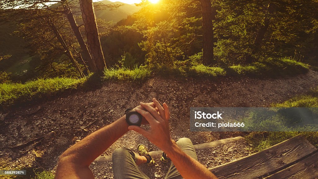 POV Trail running in the forest: checking smart watch Point of View Stock Photo