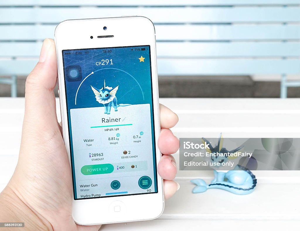 pokemon go game rainer Bangkok, Thailand - Aug 13, 2016 : Hand holding i5 of Water-type Pokemon called Vaporeon or Rainer (Bubble Jet pokemon, evolves from Eevie).Concept of hunting Pokemon for Pokemon Go game launched in July 2016 worldwide. Adventure Stock Photo