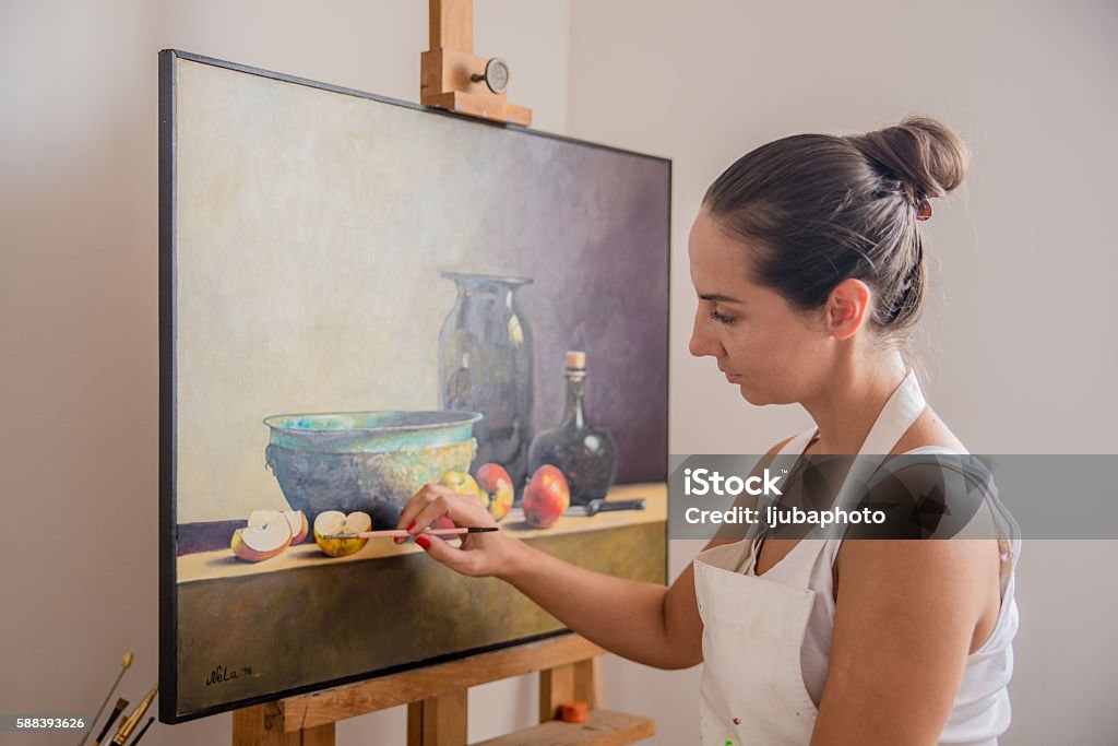 Female Artist Painting In Studio Female Artist Painting In Studio, Young woman painting for fun at home,  image of a lovely artist busy with painting 30-39 Years Stock Photo