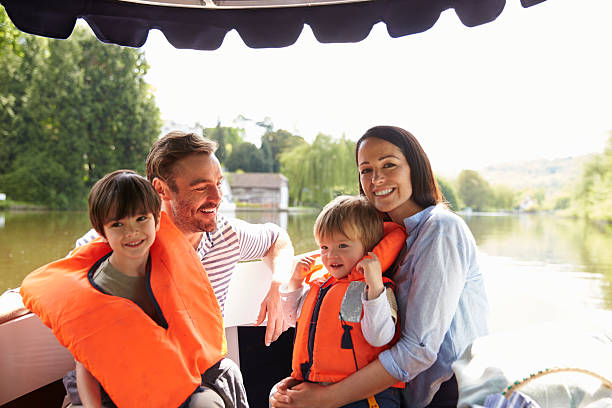 family enjoying day out in boat on river together - nautical vessel motorboating motorboat fun imagens e fotografias de stock