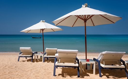 Sun Loungers On An Idyllic Empty Beach Resort In Phuket, Thailand