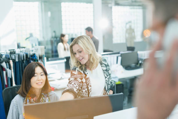 istock Fashion designers working at computer in office 588482143