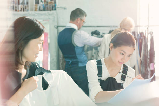 istock Fashion designers taking notes on clothing 588482481