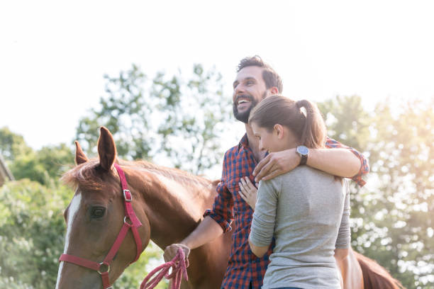 istock Smiling couple hugging near horse 588482635