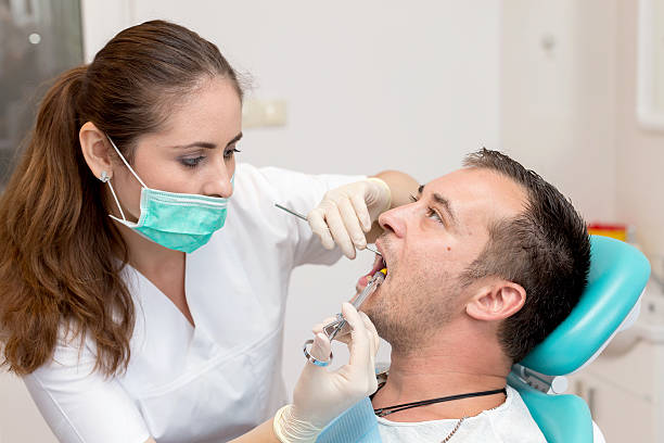 dentist giving an injection of anesthesia to the patient - affraid imagens e fotografias de stock